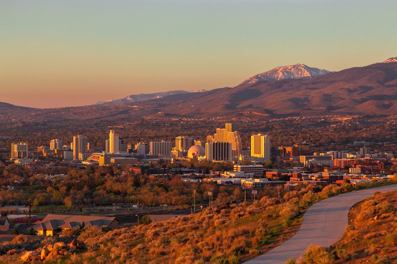 Image of Reno cityscape with mountains in background by Trevor Bexon from Wikimedia Commons